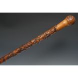 A Japanese bamboo walking stick, well carved with samurai in battle, 87cm long, Meiji period
