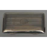 An Edwardian silver rectangular card case, sprung-hinged cover centred by a vacant circular