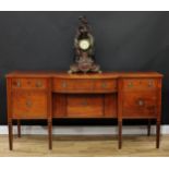 A 19th century mahogany bow-centre sideboard, crossbanded oversailing top above an arrangement of
