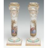 A pair of Meissen porcelain candlesticks, each column well-painted in the 18th century taste with