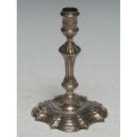 A George II cast silver taper stick, knopped pillar, shaped square base, 11cm high, London 1747, 3.