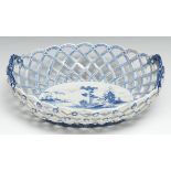 An early Derby two-handled oval basket, central oval reserve painted in underglaze blue with a