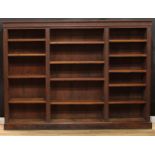 A late Victorian oak library open bookcase, carved throughout in the 17th century taste,
