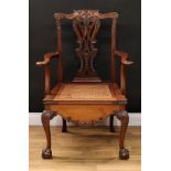 A Chippendale Revival mahogany commode open armchair, shaped cresting rail carved and applied with