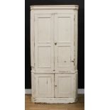 A 19th century painted pine country house floor-standing corner cupboard, moulded cornice above