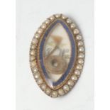 A George III gold coloured metal navette shaped mourning brooch, enclosing a lock of hair and