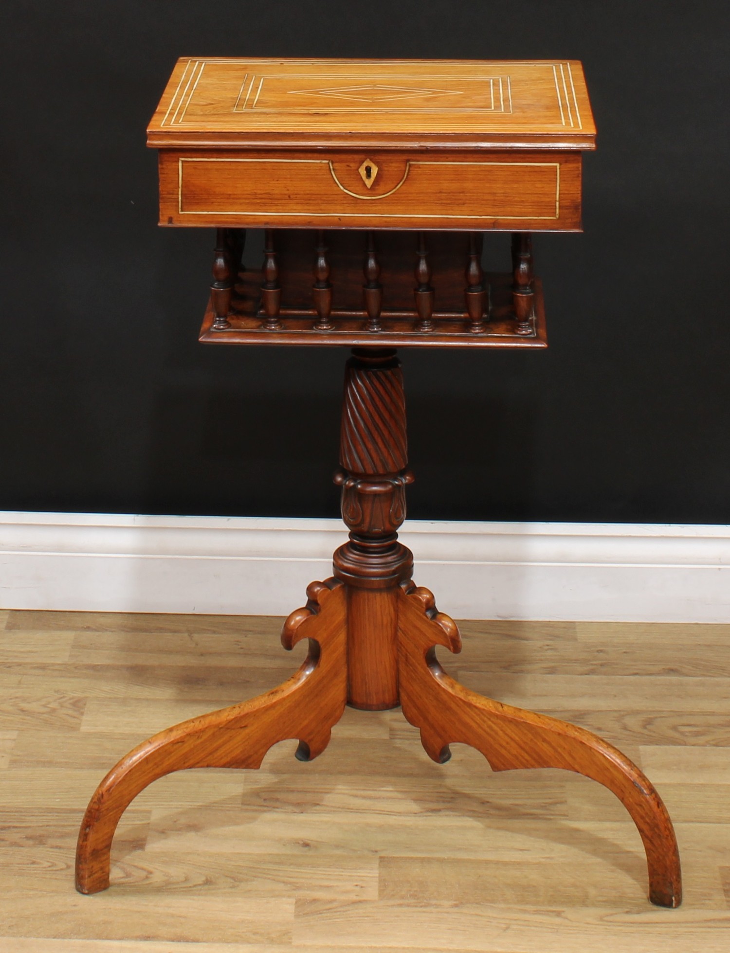 A 19th century Anglo-Indian rosewood tripod work table, hinged top enclosing a fitted interior