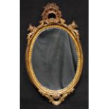 A 19th century giltwood and gesso looking glass, flower and leafy scroll cresting, oval mirror