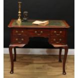 A George II Revival mahogany kneehole desk, shaped rectangular top with inset tooled and gilt