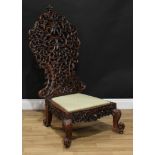 A 19th century Anglo-Burmese mahogany chair, tall cartouche-shaped back profusely pierced and carved