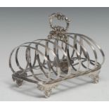 An early Victorian silver seven-bar toast rack, leafy loop handle, arched divisions, cartouche