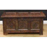An 18th century oak blanket chest, hinged cover enclosing a till, above a lunette carved frieze