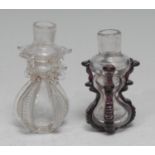 A small 18th century cruciform glass flask or phial, hourglass reservoir applied with purple lugs,