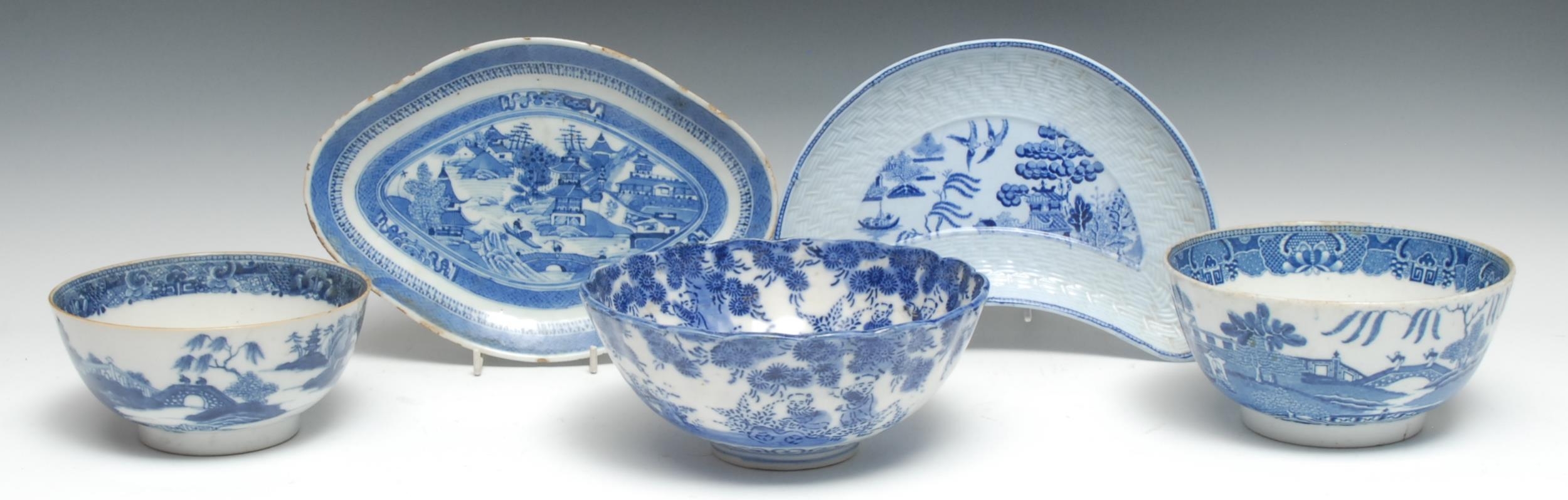 A Chinese rounded navette-shaped dish, painted with a stylized landscape in underglaze blue,