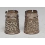 A pair of 19th century Indian silver novelty peppers, each as a castle chess piece, chased with