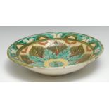 A Della Robbia dish, incised with stylised leaves and foliage in mottled tones of green aND