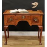 A Queen Anne Revival walnut lowboy, crossbanded quarter-veneered top outlined with herringbone