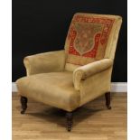 A late Victorian 'carpet' armchair, scroll arms, stuffed-over upholstery, ring-turned forelegs,
