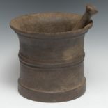 An 18th century cast iron mortar, flared rim, centre girdle, 17.5cm high