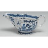 A Bow sauceboat, painted in blue underglaze with a house in a Chinese landscape, cell border, 20cm