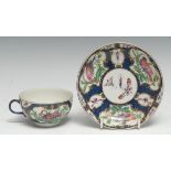 A Worcester teacup and saucer, decorated with vase and fan shaped cartouches containing fanciful