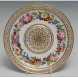 A 19th century Sevres breakfast cup stand, painted with a circular band of flowers, within trellis