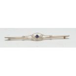 A diamond and sapphire target panel brooch, central square cut sapphire within open cast lozenge