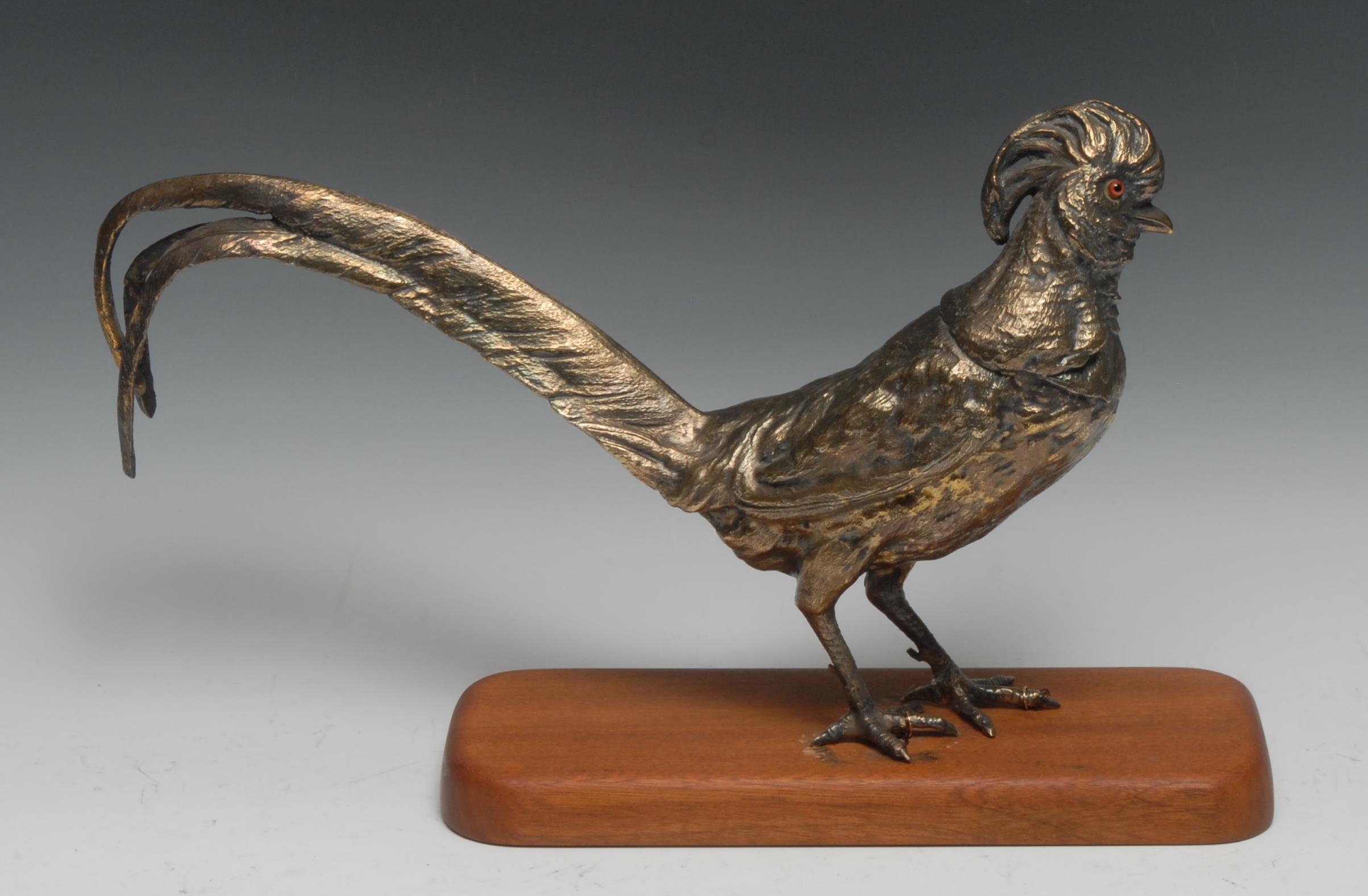 An Elizabeth II silver gilt table decoration, as a pheasant, glass eyes, 36cm long, London 1974,