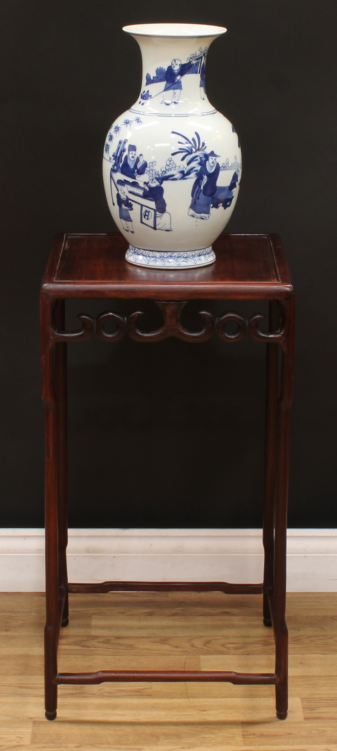 A Chinese hardwood jardiniere stand, panel top above a deep frieze pierced and carved with