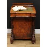 A Victorian walnut Davenport, hinged sloping top with inset tooled and gilt leather writing surface,