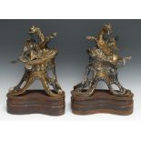 A pair of 19th century bronze chenets, cast as a wyvern and a winged horse, each above Rococo