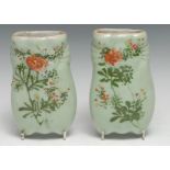 A pair of Chinese celadon wall pockets, moulded decorated in polychrome enamels with flowers, 15cm