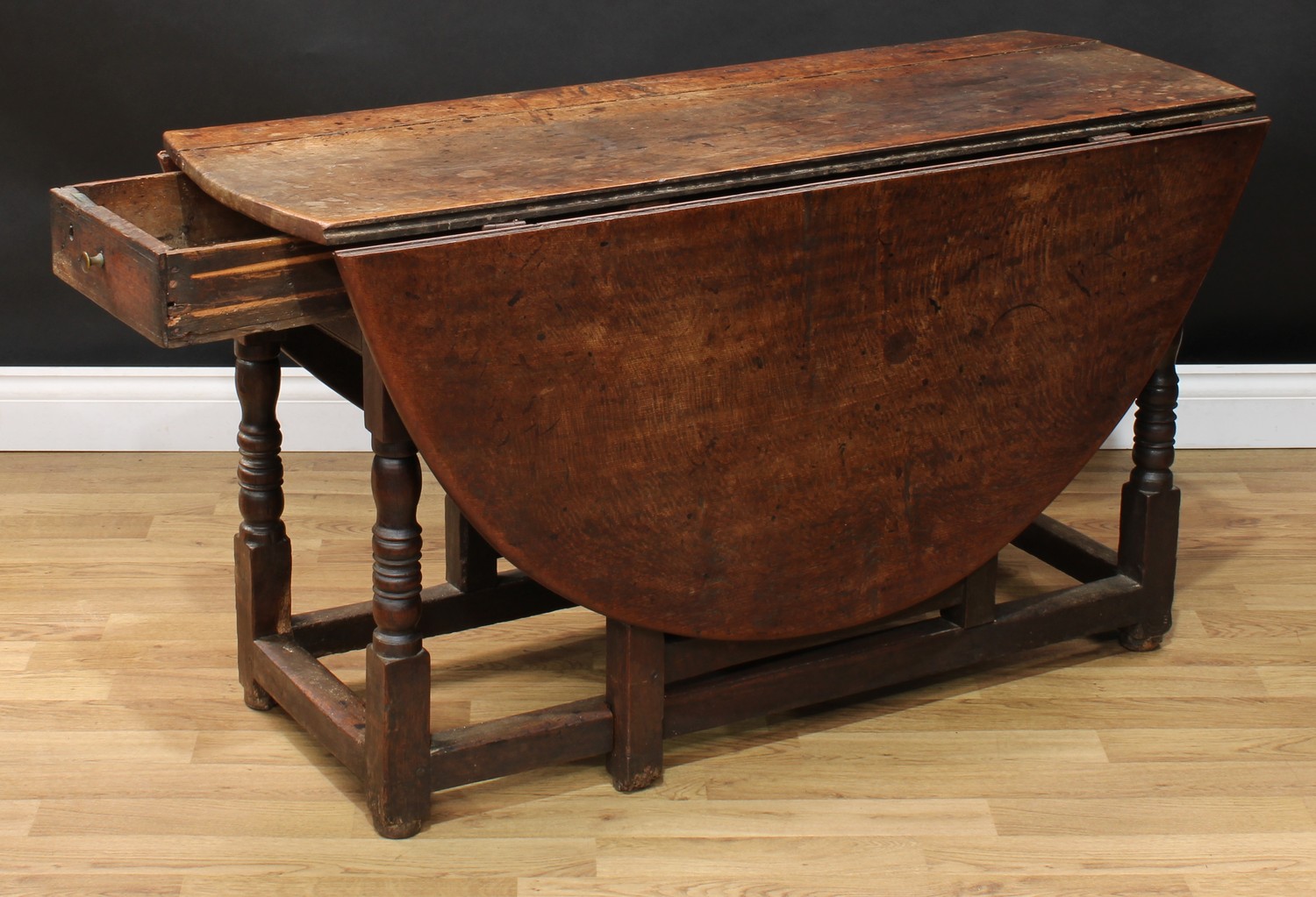 A 17th century oak gateleg table, oval top with fall leaves above a frieze drawer, turned and - Image 3 of 4