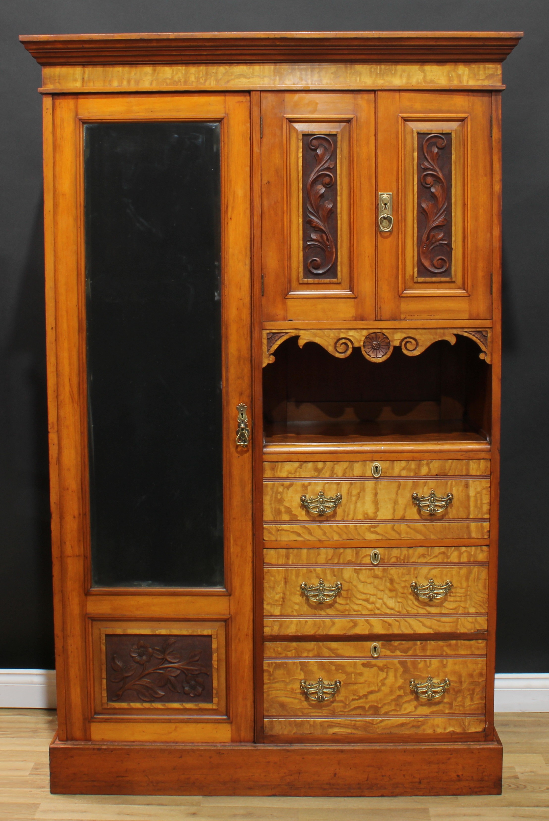 A late Victorian curly maple accented wardrobe, outswept cornice above a three-quarter mirrored door