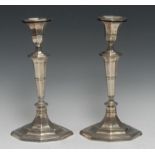 A pair of George V silver table candlesticks, detachable nozzles, tapered stems, reeded borders,