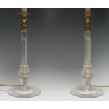 A pair of Regency design cut glass columnar table-lamps, milled brass sconces, circular bases,