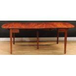 A George III mahogany concertina-action dining table, rounded rectangular top with fall leaves and