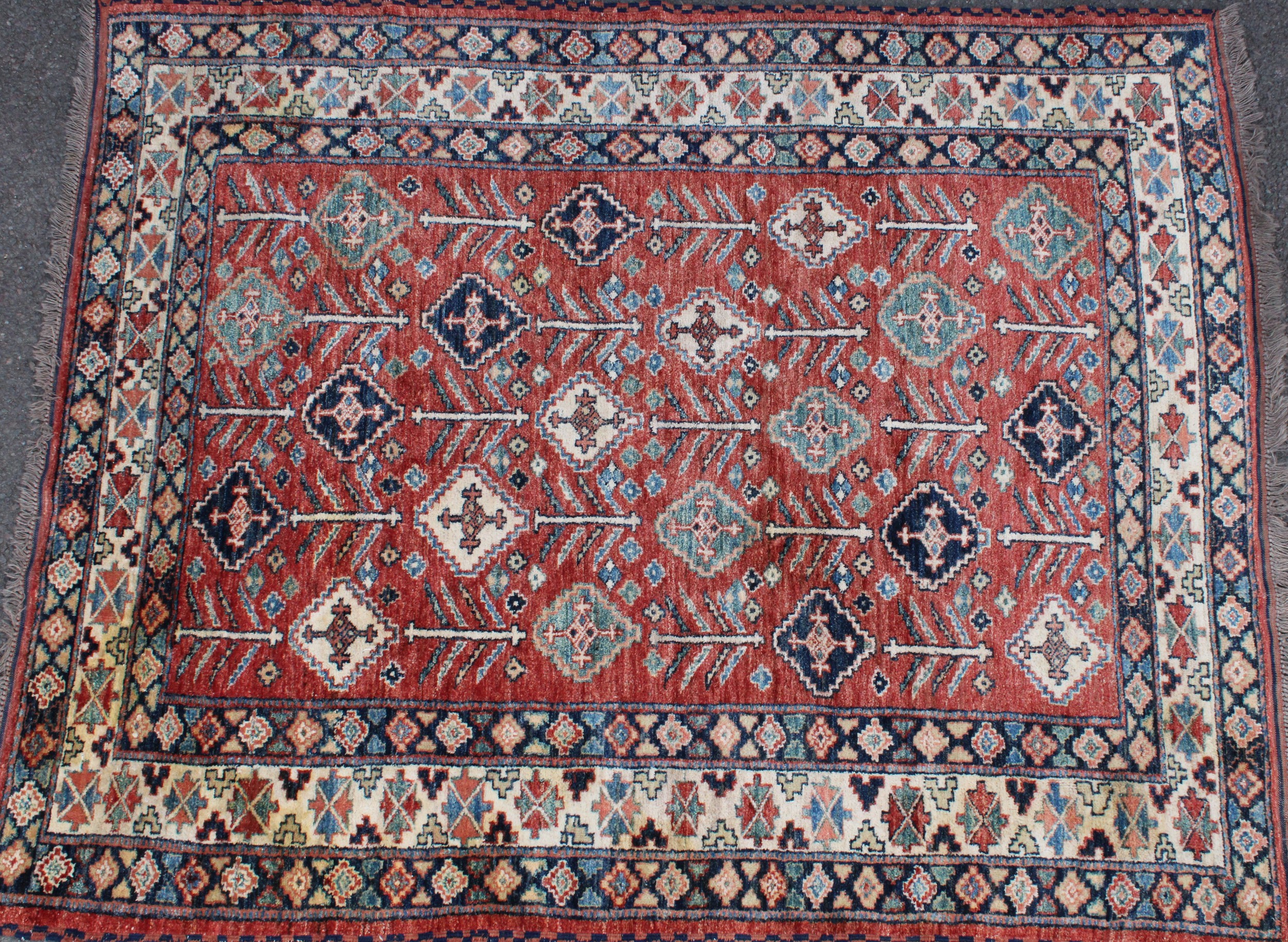 A Middle Eastern woollen carpet, worked in the traditional manner, 188cm x 154cm