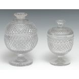 An early 20th century heavy strawberry cut glass sugar box and cover, star cut flattened button