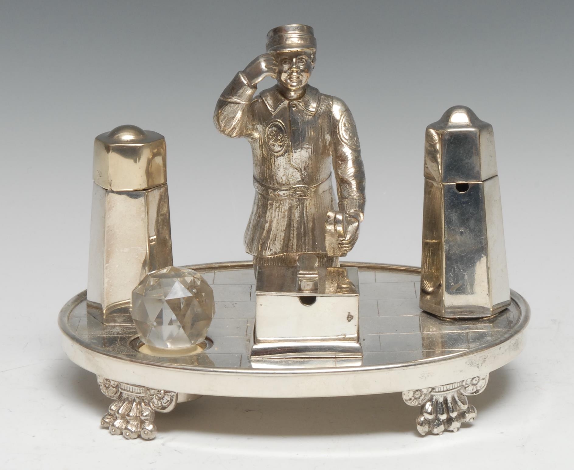 An early 20th century silver plated novelty cruet, as a shoe shine boy, oval base, lion paw feet,