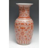 A Chinese porcelain baluster vase, painted in tones of iron red with bats, chrysanthemums and