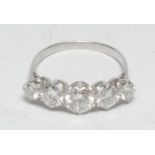 A five stone diamond line ring, linear set with five graduated round brilliant cut diamonds from