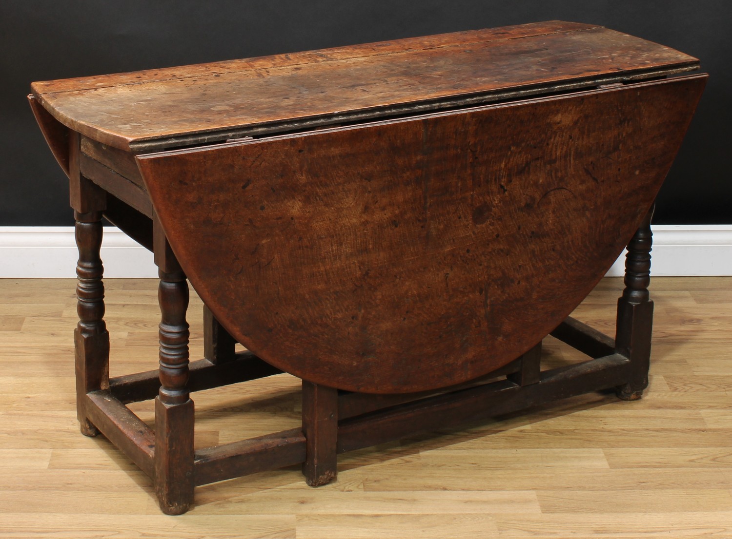 A 17th century oak gateleg table, oval top with fall leaves above a frieze drawer, turned and - Image 2 of 4