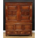 An 18th century oak housekeeper's cupboard, outswept corince above a pair of rectangular cupboard