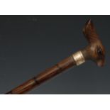 An early 20th century novelty walking stick, the softwood handle carved as the head of a hare,