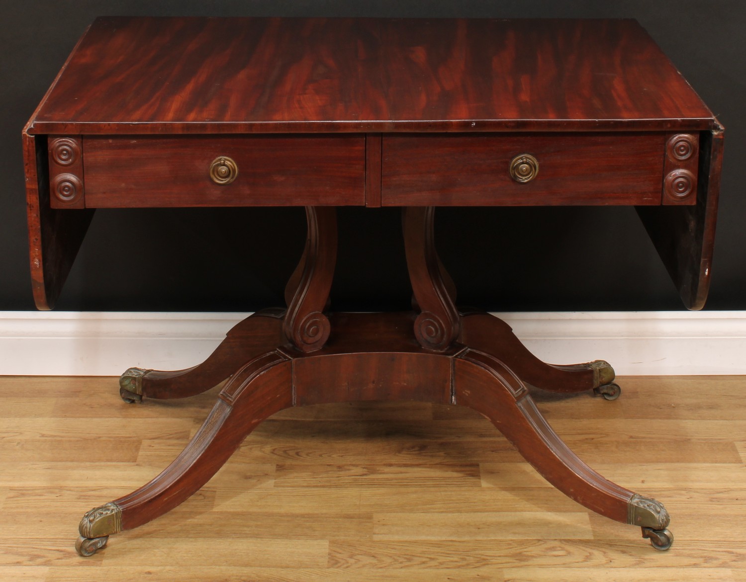 A William IV mahogany sofa table, rectangular top with fall leaves above a pair of frieze drawers,