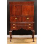 A George II Revival mahogany cabinet on stand, concave moulded cornice above a pair of doors, a