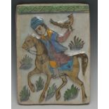 A Middle Eastern Islamic rectangular tile, moulded and painted in the typical Qajar manner with a