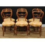 A set of six Victorian walnut balloon back dining chairs, each shaped cresting and mid rail carved