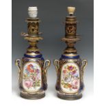 A pair of Continental porcelain table lamps, painted with colourful summer flowers, picked out in